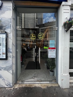 Glass doors. Push from middle to open. Small step through door.
