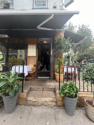 Glass door with black frame. Pull from left to open. Two large steps up ahead of entrance.