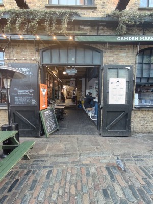 Black framed glass gates. Pull from centre to open. Path after doors going left to entrance. Front area after doors.