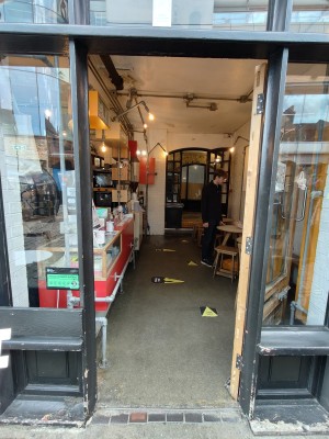 Black framed glass door. Push black handle on right to open.