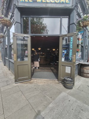 Green framed glass doors. Pull from centre to open.