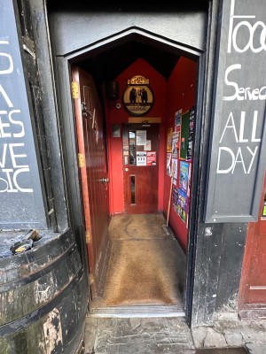 Brown, wooden door brown, metal handle on right. Push to open.