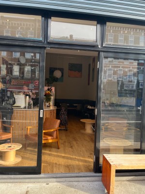 Manual glass door opens using push motion with metal handle to left.