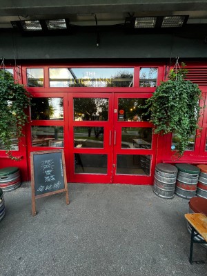 Glass double doors with red frame. Pull from middle to open.