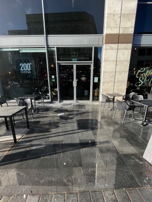 From sidewalk facing place. Path to entrance between outdoor street seating areas. Doors directly ahead.