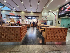 Open doorway leads through outdoor front area to service counter and indoor main area ahead.