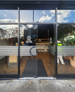Glass doors with black, frames. Push from middle to open.