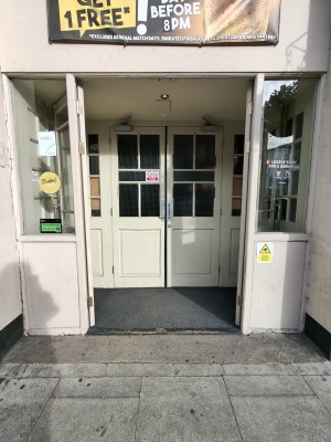 Facing white glass doors. Push from centre to open.