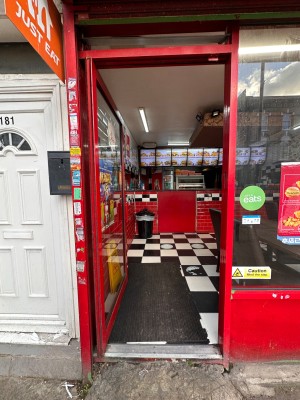Red framed glass door. Push red metal handle on right to open.