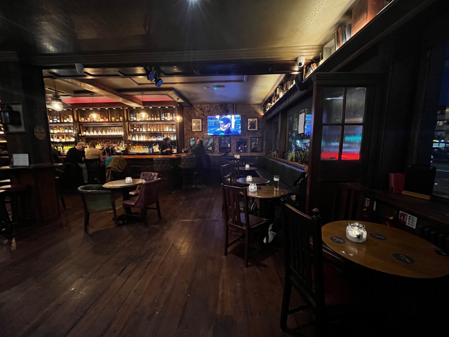 From entrance facing slightly right. Tables with chairs on right wall ahead followed by half booths.