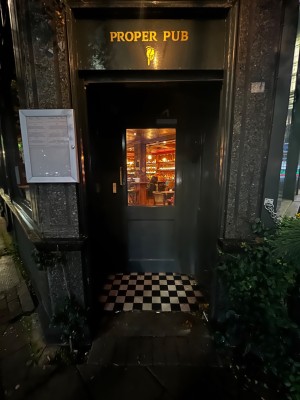 Glass door with grey frame. Pull from left to open. Built in ramp leading up to door.