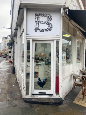 White framed glass door ahead. Push from left to open.
