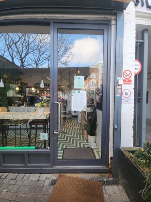 Dark grey bordered door. Handle on left. Pull to open.