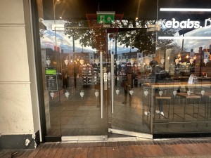 Double glass door with handles on the center. Push.