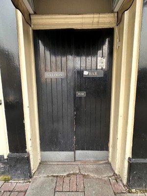 Black doors ahead. Push from centre to open.