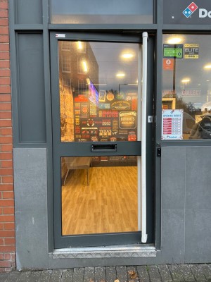 Black framed glass door ahead. Push from right to open.