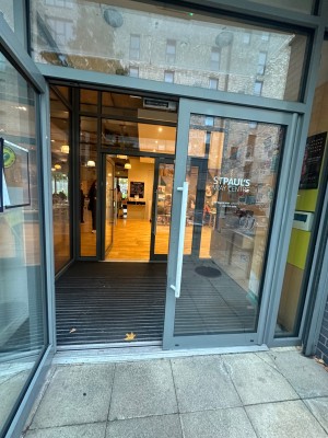 Double glass door with handles on the center. Pull to open.