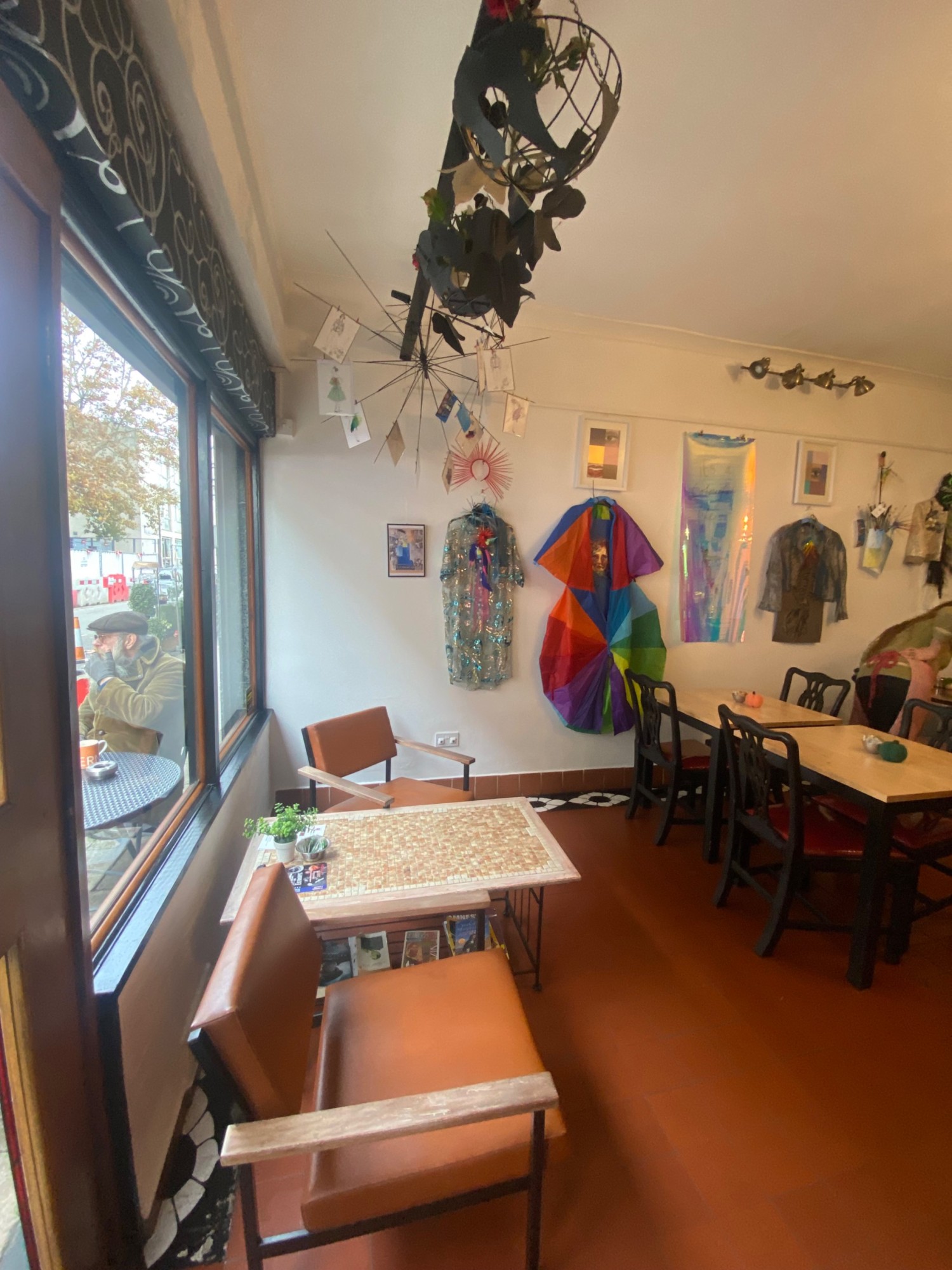 From entrance facing left. Low table with chairs ahead. Tables with chairs to back right.