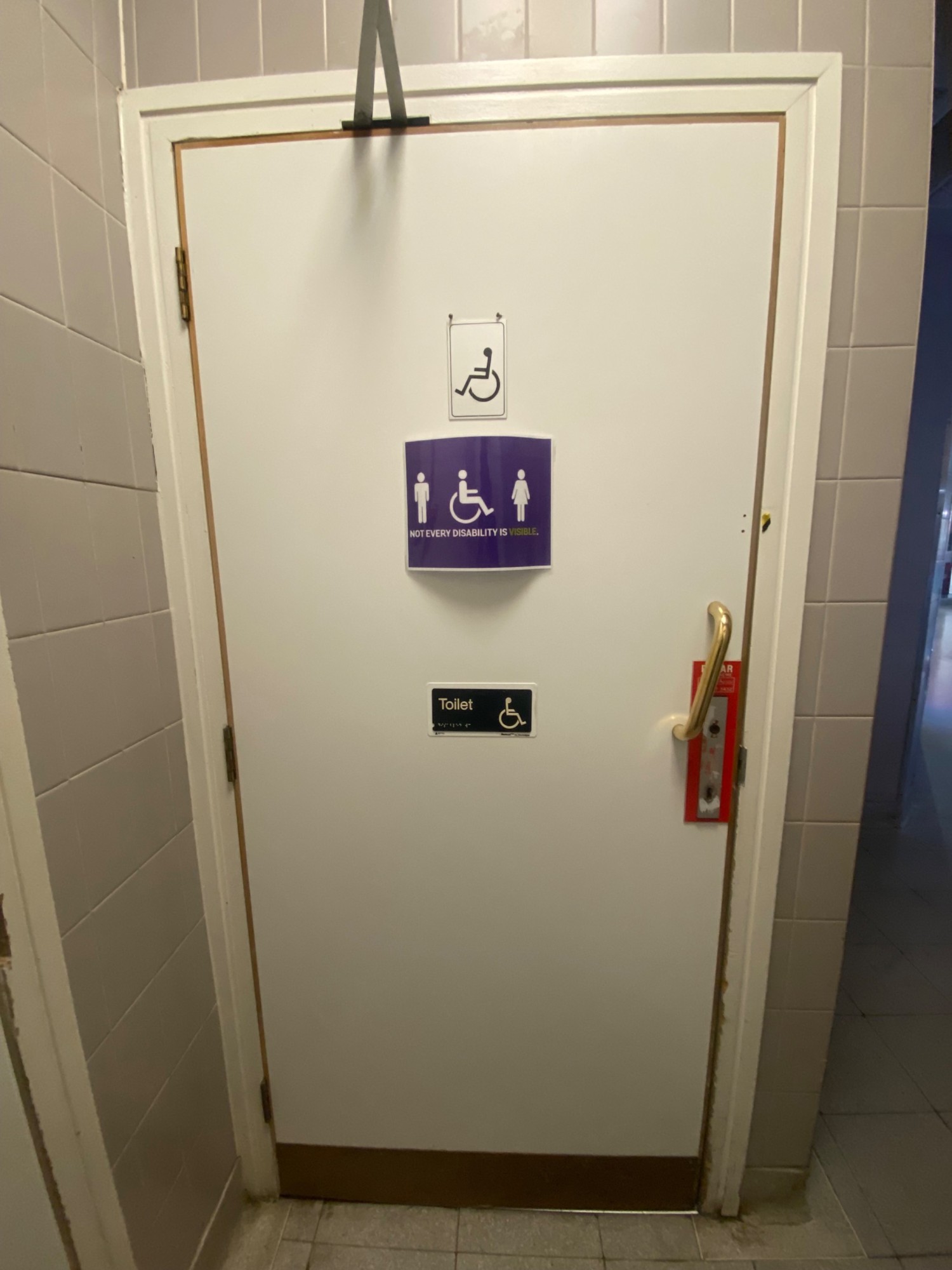 From in front of bathroom door, looking right. White, wooden door ahead. Silver radar lock on right. Pull golden handle on right to open.