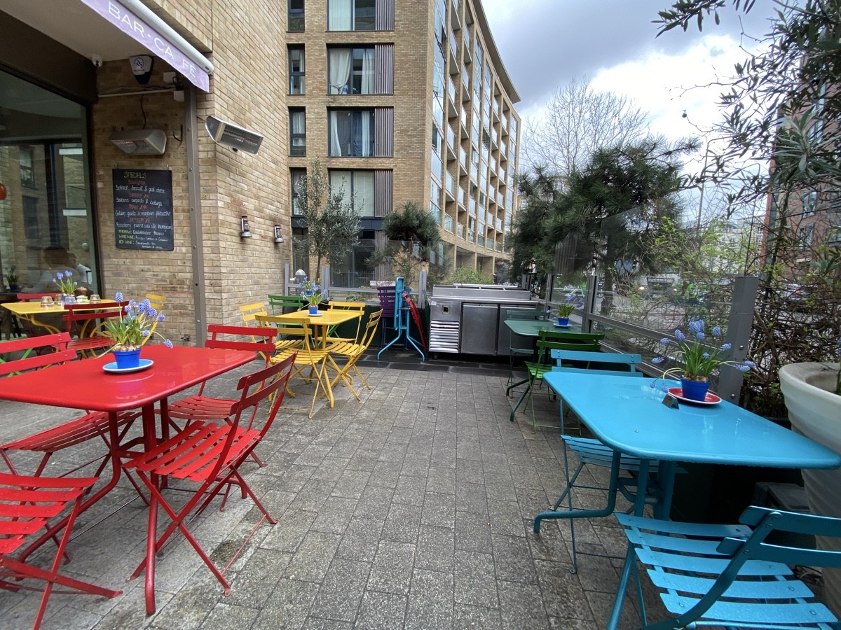From after entrance facing right. Tables and chairs along both sides.