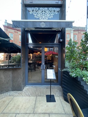 Double glass doors. Pull from centre to open. Menu stand obstructing to right.