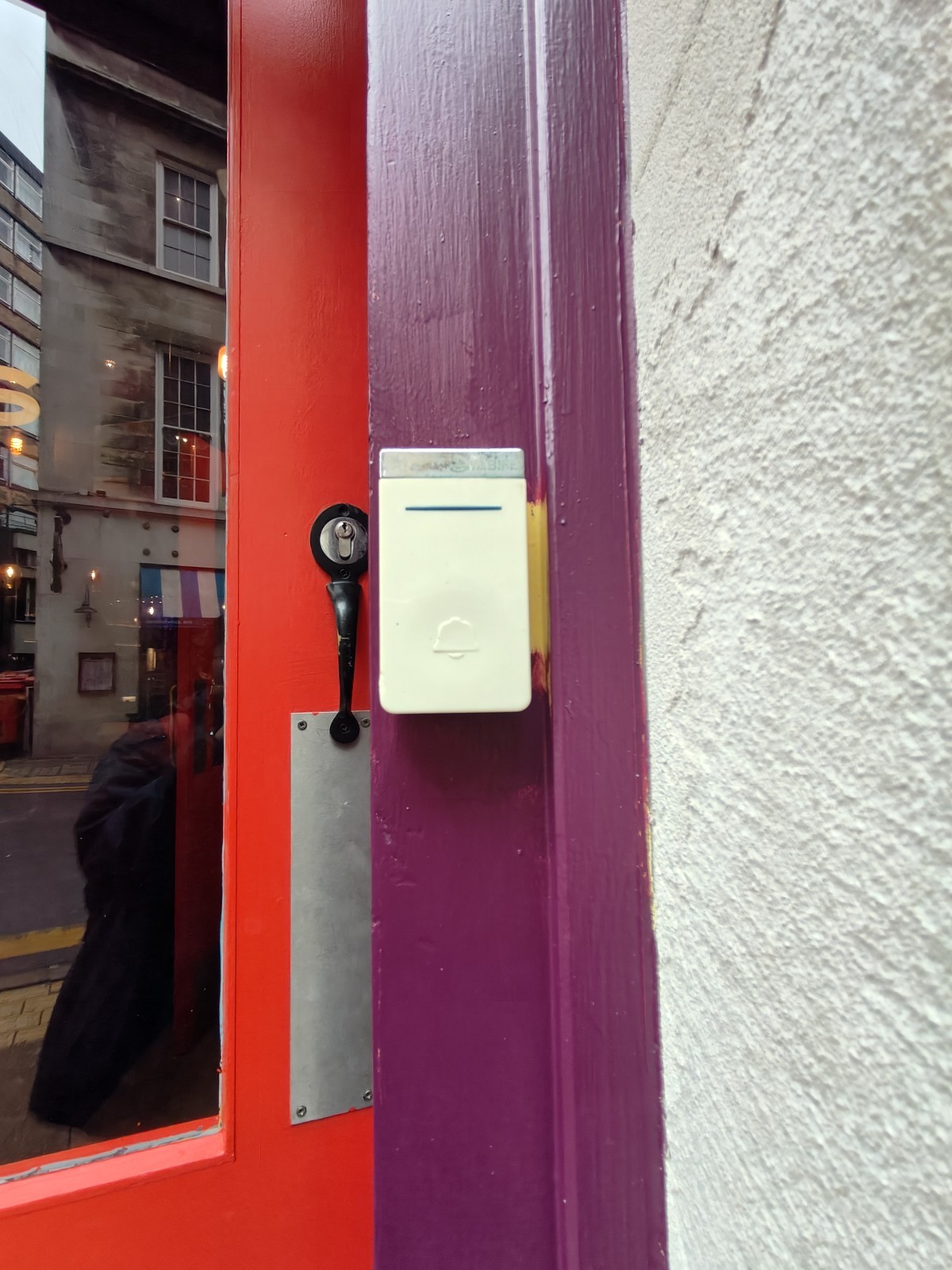 Doorbell for assistance on right of door.