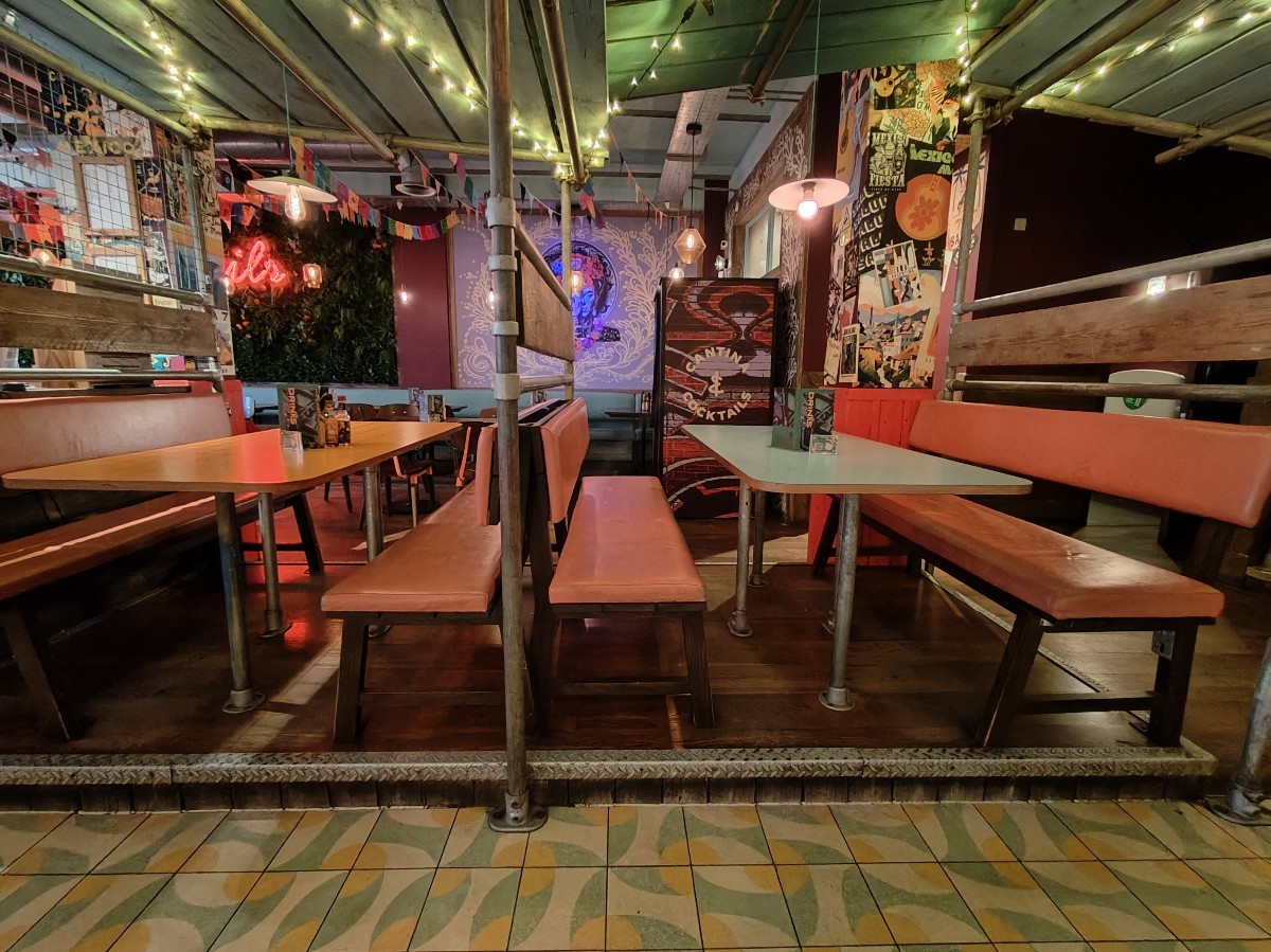 From bar facing left. Booths ahead with wall dividers separating them.