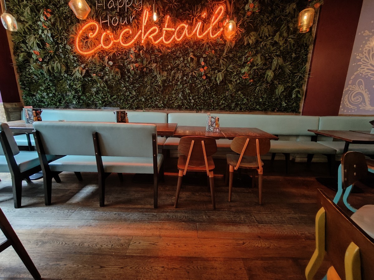 From entrance facing left. Half booth along back wall.