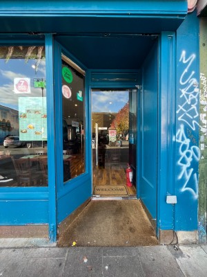 Blue framed glass door. Pull silver handle on left to open.