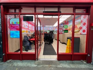 Facing entrance. Single manual glass door outlined in red. Push from right to open.