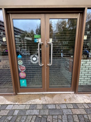 Brown framed glass doors. Pull silver handles in centre to open.