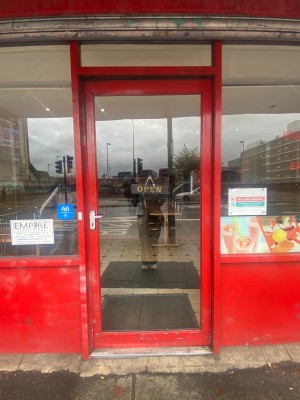 Red framed glass door. Push silver handle on left to open.