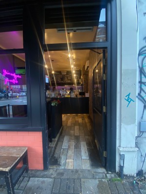 Single black door with window. Push from left to open.