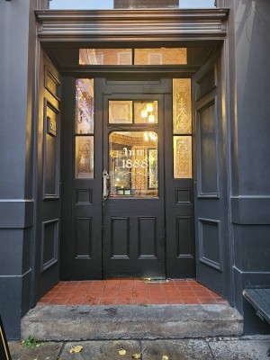 Large step to enter followed by 2 sets of doors; double doors opening inwards from the centre, then a single glass door opening inwards left to right.