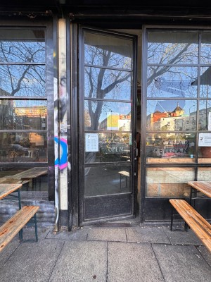 Glass and metal door. Push from right to open.