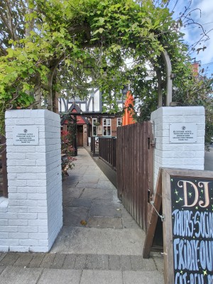 Preceding wooden gate. Push from left to open. Path after gate to entrance at back.