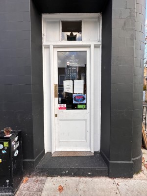 Wooden and glass door. Push from left to open.