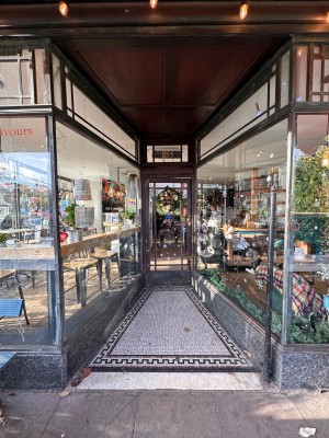 Glass open archway and ramp leading to entrance.
