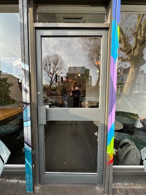 Manual glass entrance door. Pull from left.