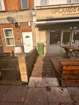 Wooden ramp leading to entrance ahead.