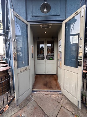 First set of wooden & glass doors. Pull from center to open.