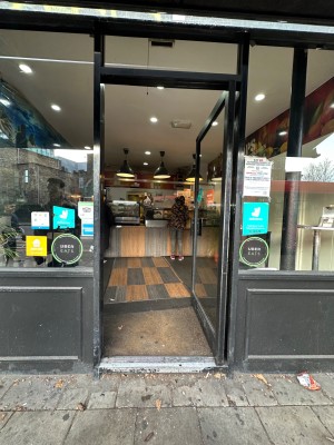 1 step followed by single glass door, push to open.