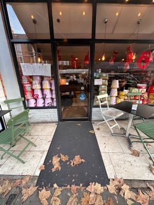 Ramp leading to entrance. Metal and glass door. Push from right to open.