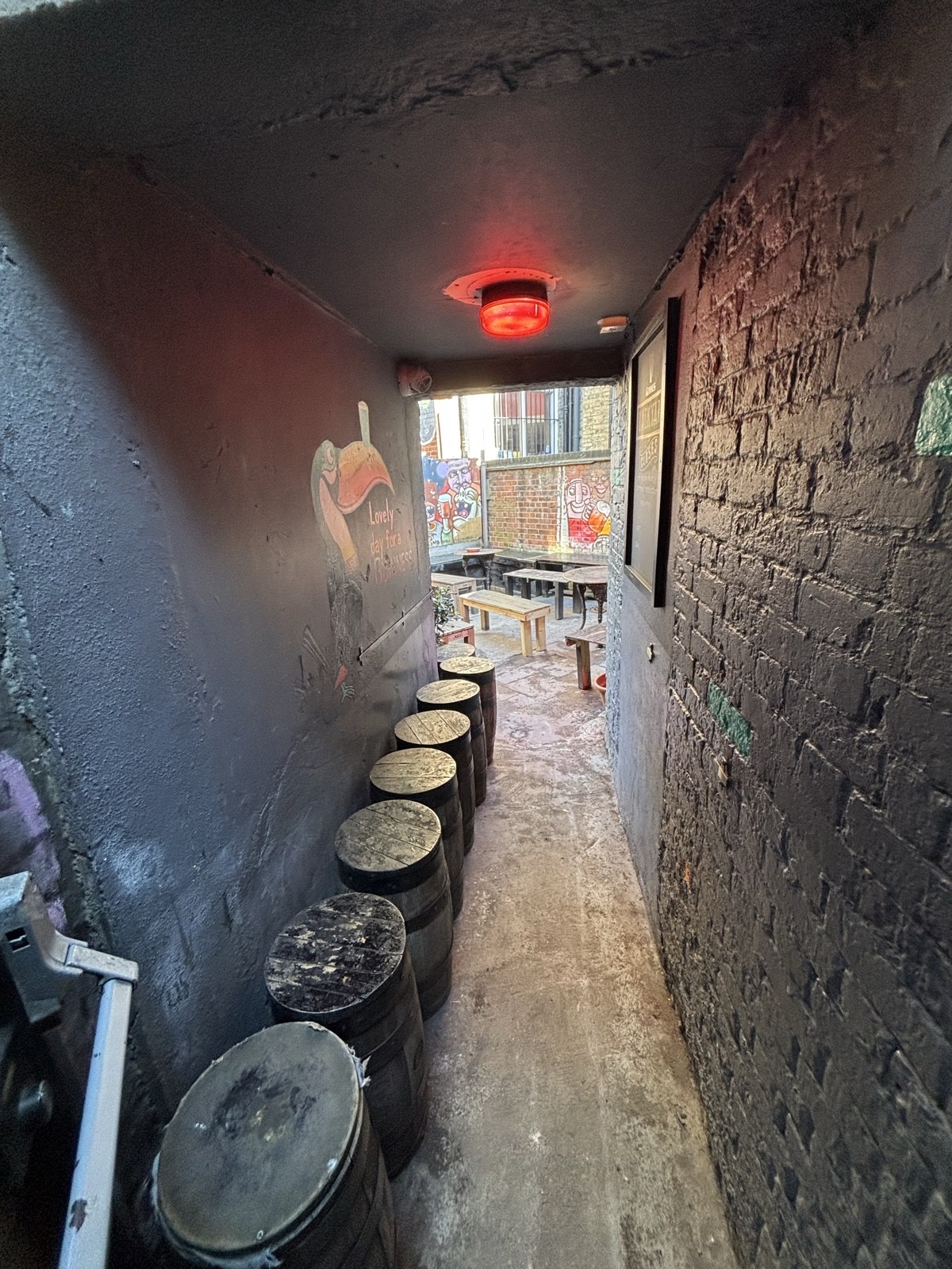 From door facing straight. Stools along left. Path ahead to opening on back.