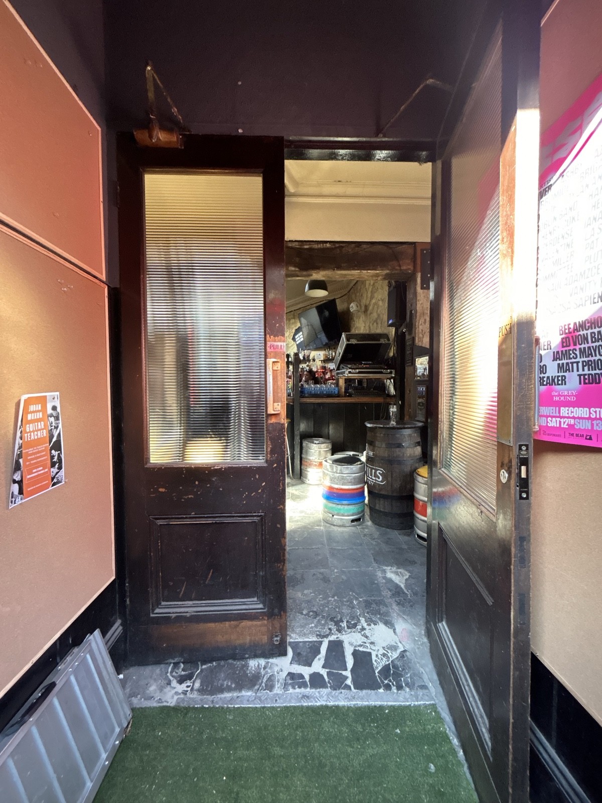 From first door facing straight. Dark wooden doors ahead with glass panels. Pull gold handles in centre to open.