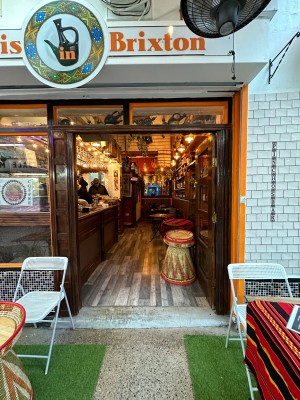 Glass door with wooden frames ahead. Push from centre to open.