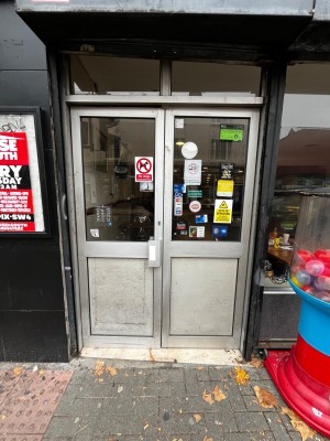 Glass double doors with grey frame. Push from middle to open.