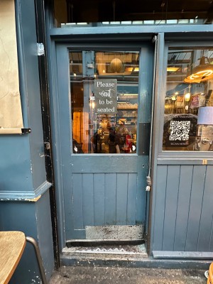 Wood and glass panelled single door. Push from right.