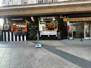 From street facing venue. Main stall at back right, side stall on back left. Standing sign ahead in middle.