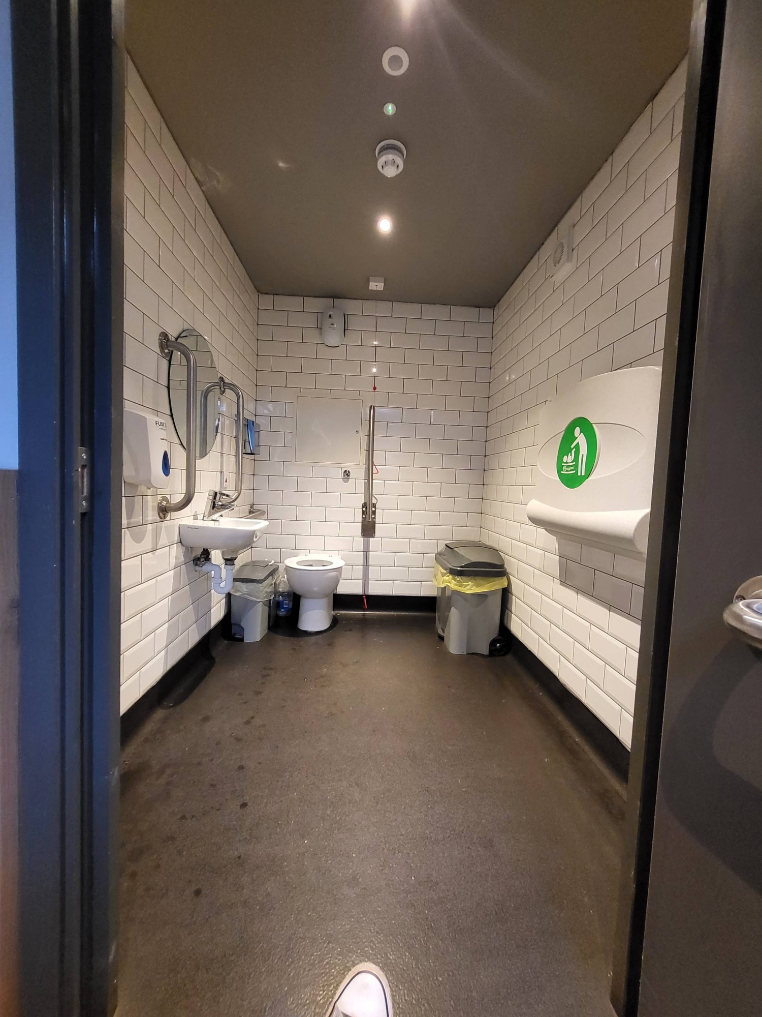 View of the disabled toilet on site. Toilet straight ahead, sink to right
Baby changing table to left.